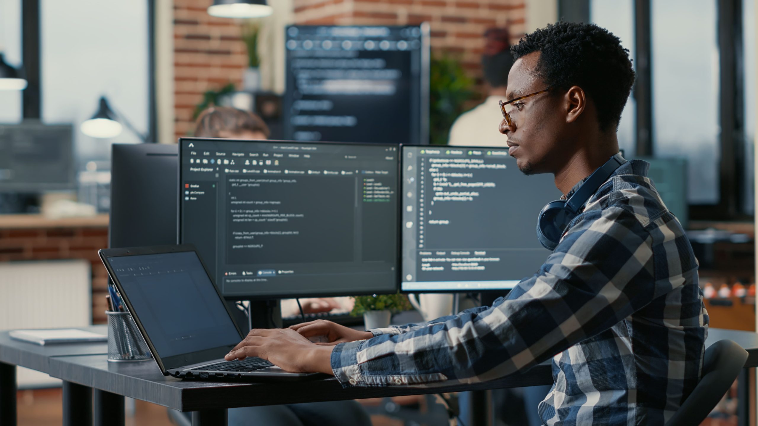 man coding at desk