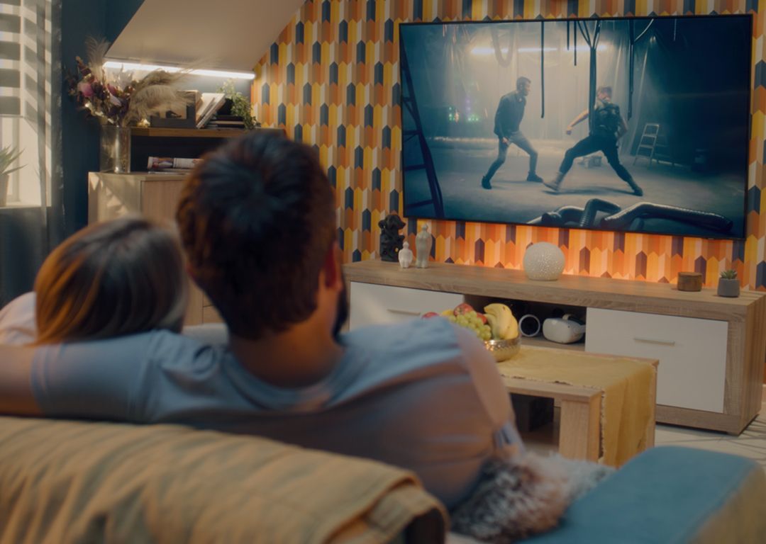 couple watching a movie on tv in living room